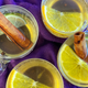 Four glasses of mulled white wine garnished with citrus and cinnamon sticks